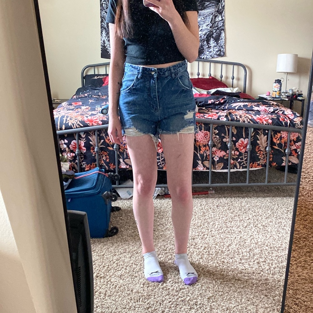 A pair of dark washed shorts